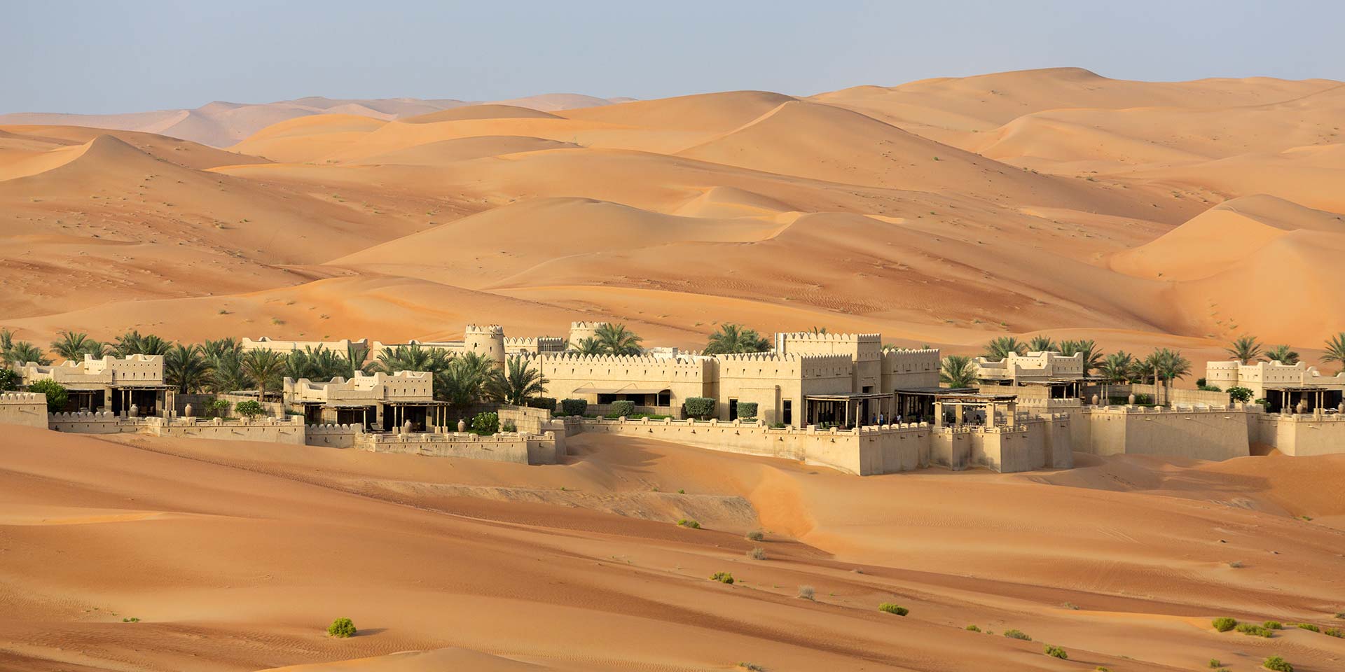 A view of ancient ruins and pyramids in a desert setting